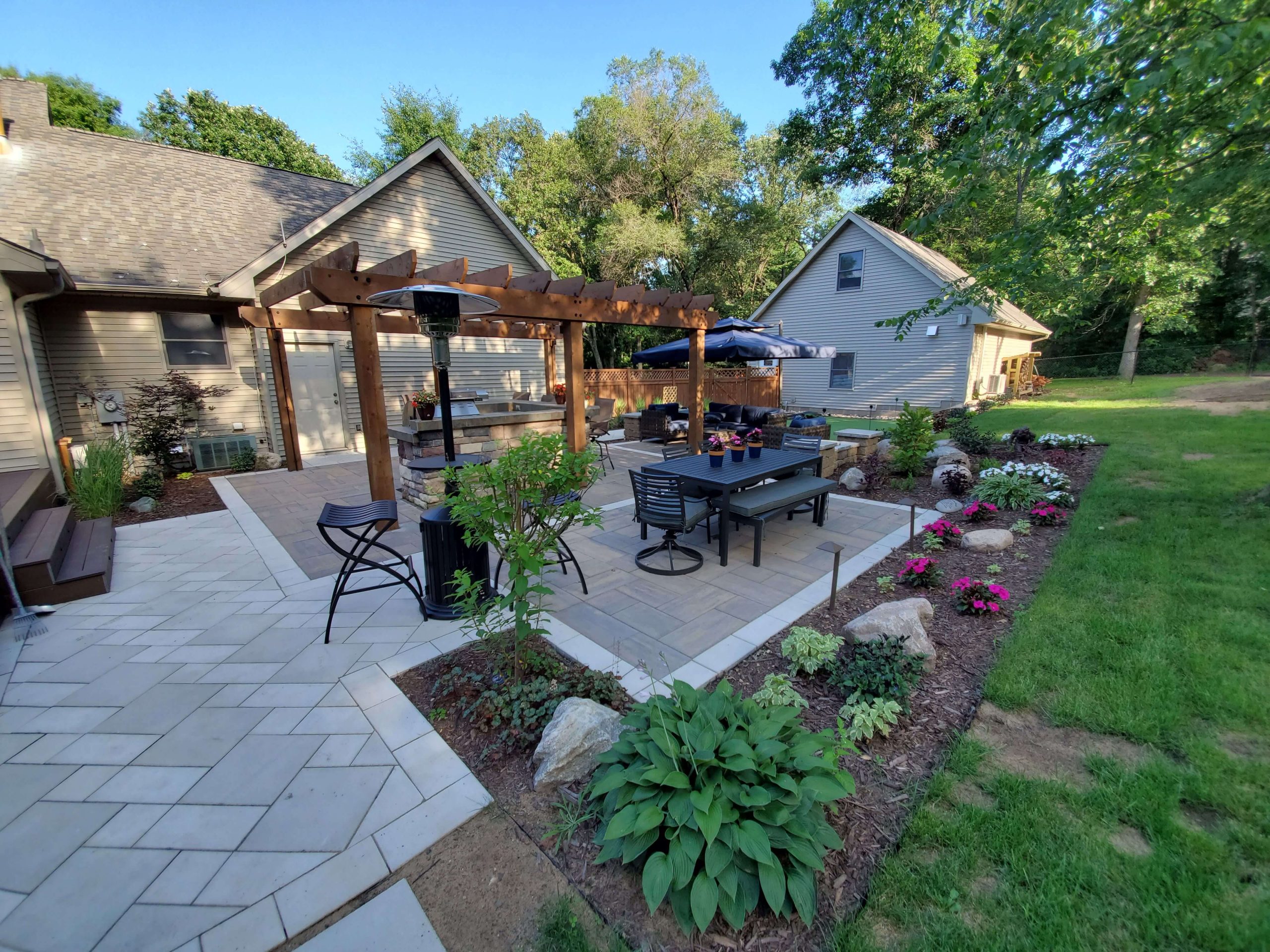 Beautiful backyard entertaining area with paver patio and pergola