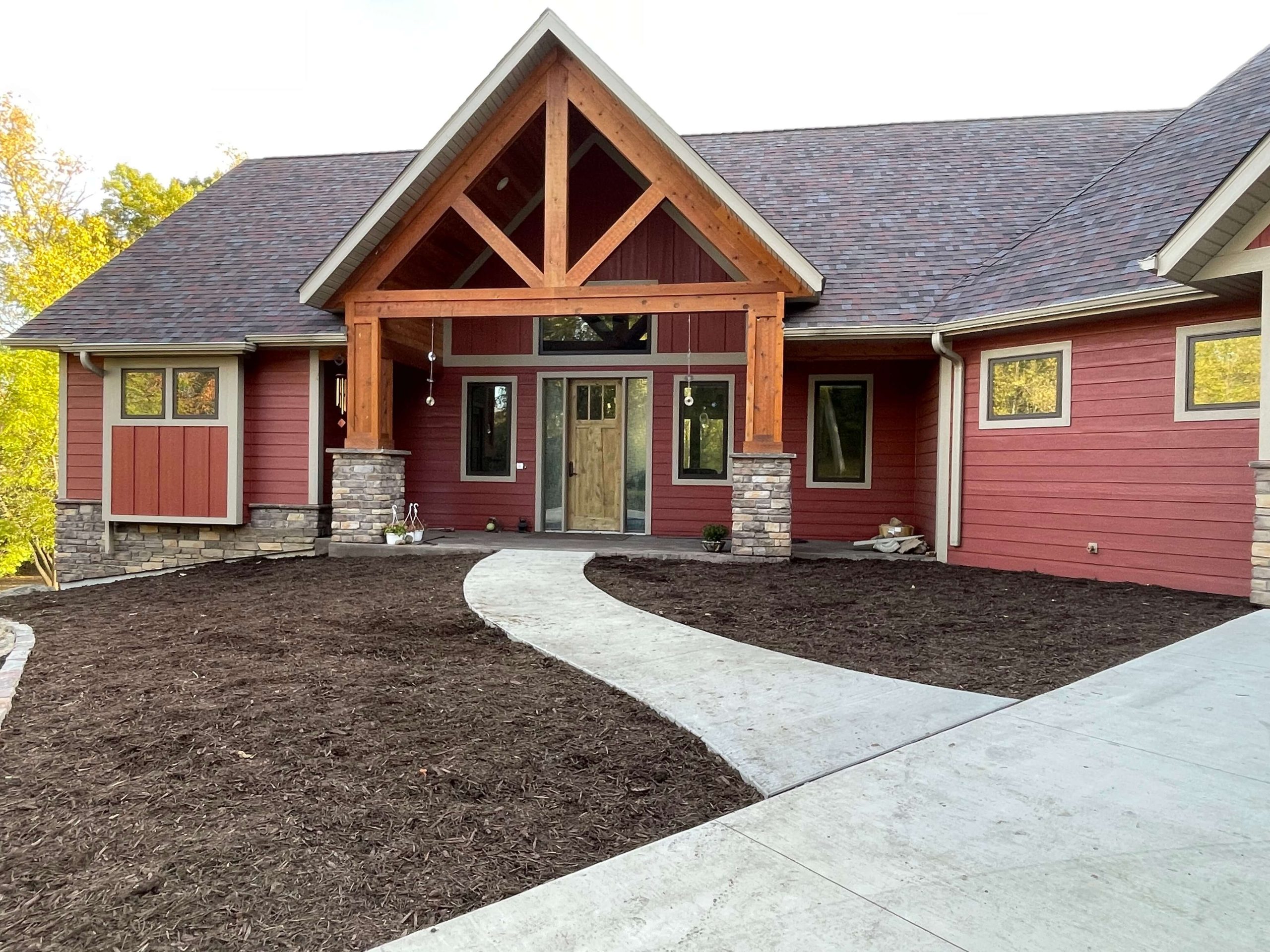 A newly mulched landscape in front of a residential home.
