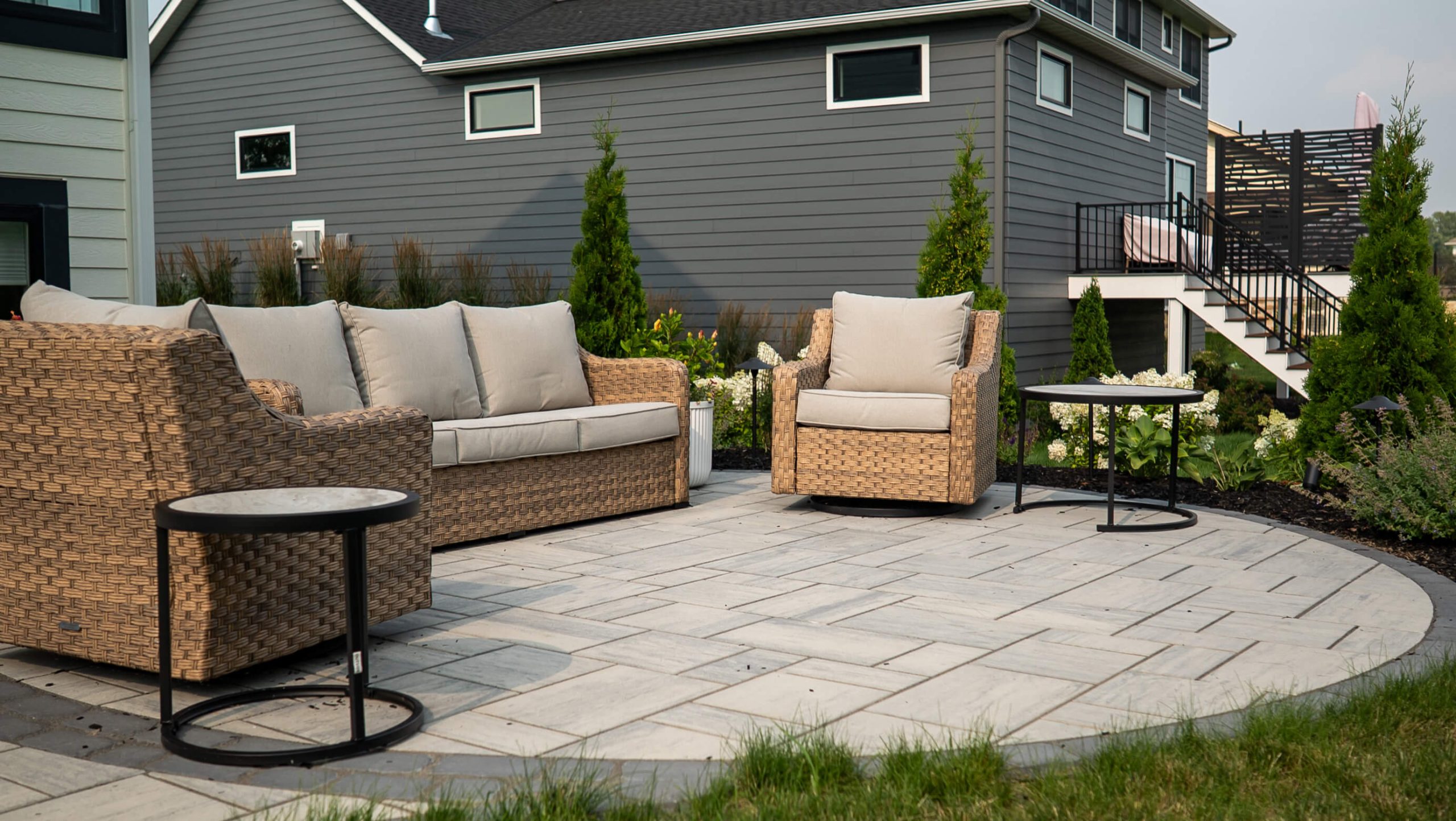 A well-designed outdoor seating area featuring a circular paver patio.