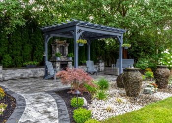 Black Pergola surrounded by beautiful landscaping